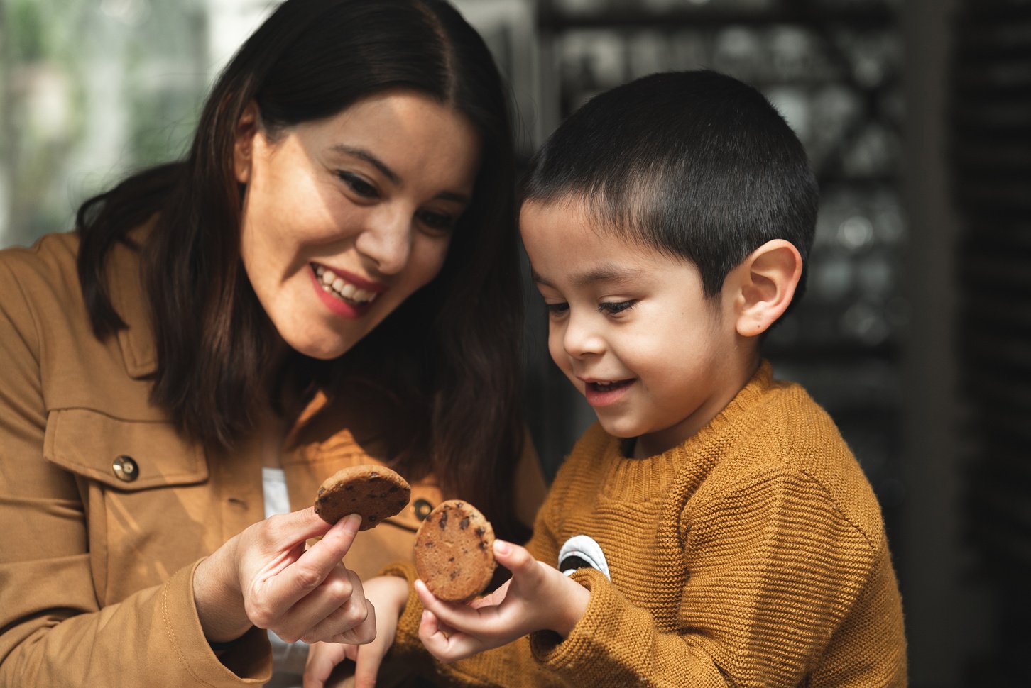 Girl with Autism Eating Cookies with Her Mother